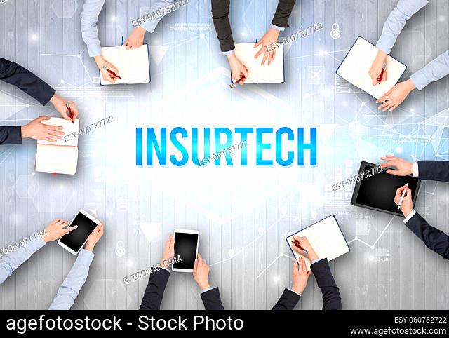 Group of Busy People Working in an Office with INSURTECH inscription, modern technology concept