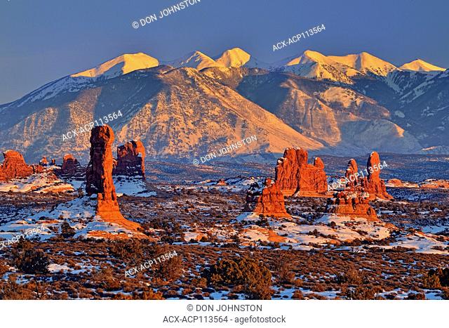 La Sal Mountains and sandstone spires at sunset, Arches National Park, Utah, USA
