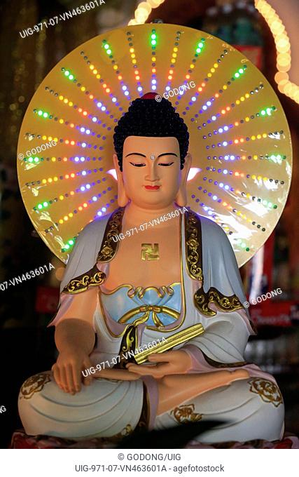 Chua Vinh Nghiem buddhist pagoda. Buddha statue with neon light in bhumisparsha-mudra posture
