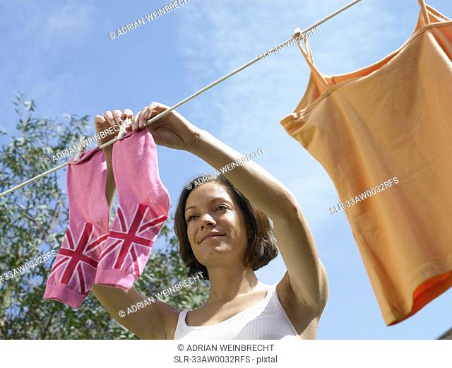 Woman hanging socks on clothesline