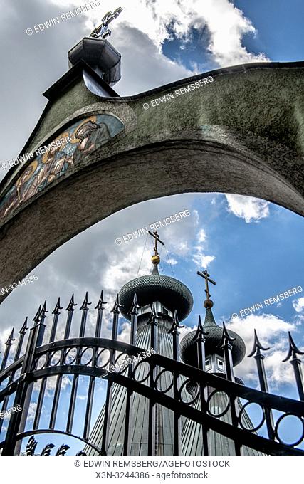 High angle view of closed iron gate with stone archway depicting Christian religious icons in front of Sabor Sviatoj Trojcy, Orthodox church, Poland