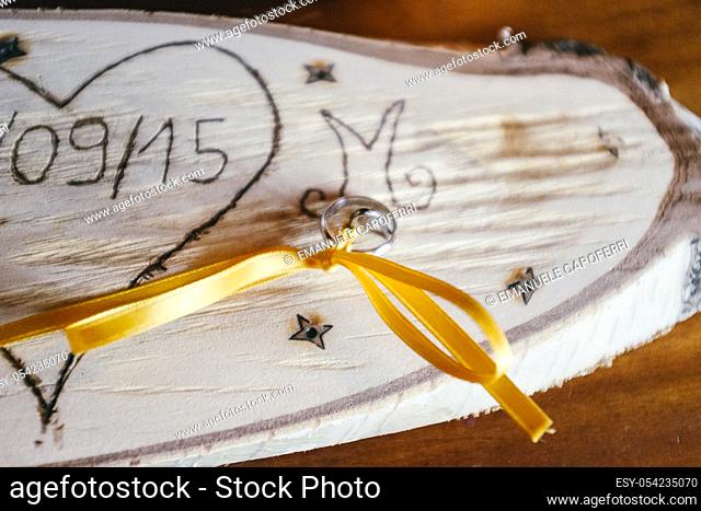 Wedding rings on a piece of wood