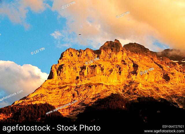 Photo of the setting sun shines on the peaks of the Swiss Alps