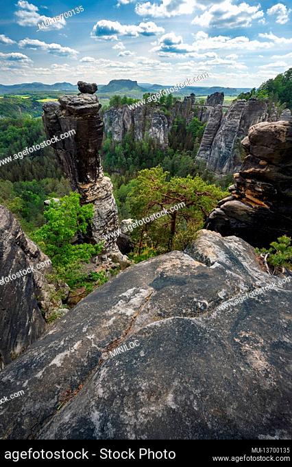 Unrecognized silhouette climber on mountain top enjoying famous Bastei rock formation of national park Saxon Switzerland, Germany