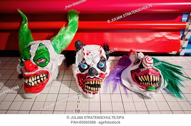 Clown masks lie on a table at 'Lutzmann Berger & Traupe, ' a specialty store for costumes and theatrical supplies in Hanover, Germany, 25 October 2016