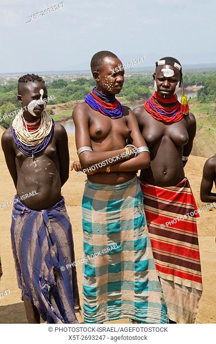 Young topless female teens and children of the Karo tribe. Photographed in the Omo Valley, Ethiopia