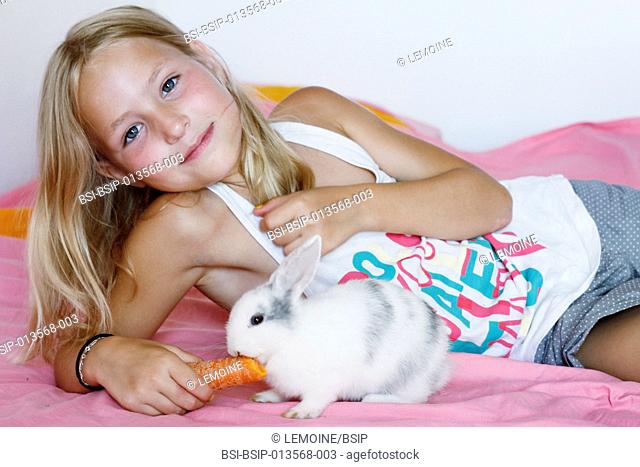 9-year-old girl with her dwarf rabbit