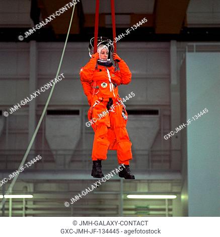 Astronaut Ellen Ochoa, mission specialist, simulates a parachute drop into water during emergency bailout training with her STS-96 crew mates