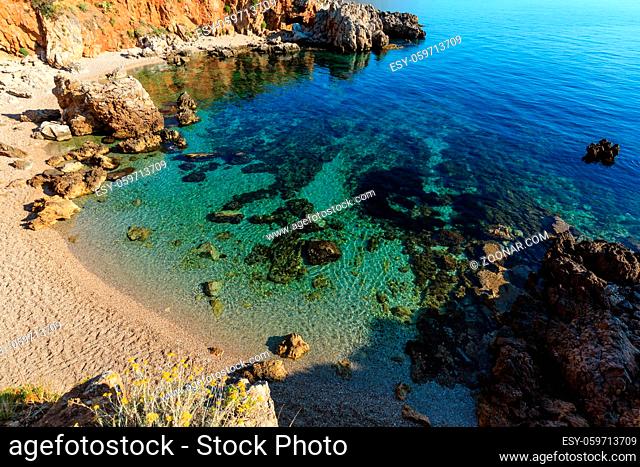 Paradise sea bay with azure water and beach. View from coastline trail of Zingaro Nature Reserve Park, Trapani province, Sicily, Italy
