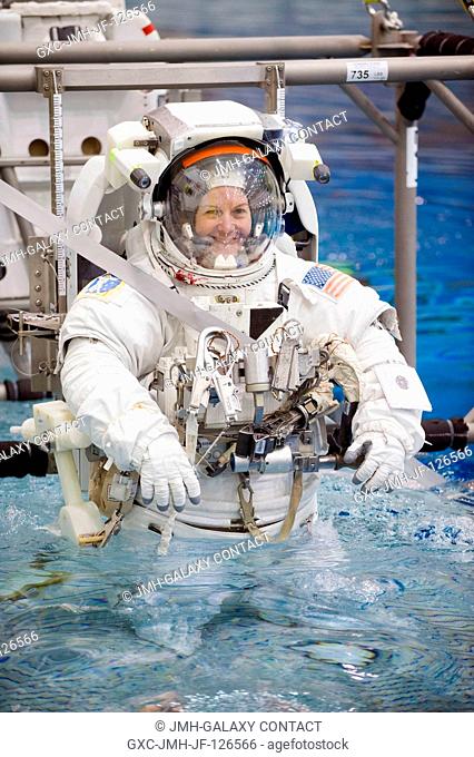 NASA astronaut Catherine Coleman, Expedition 2627 flight engineer, attired in a training version of her Extravehicular Mobility Unit (EMU) spacesuit