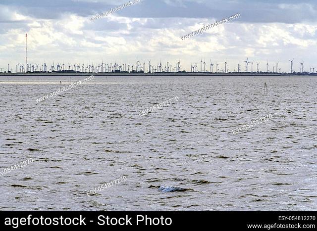 coastal scenery including a distant wind farm near Neuharlingersiel in Eastern Frisia, Germany