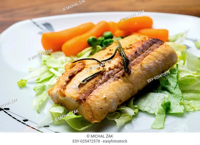 Image of salmon fillets served on a plate with mixed salad and rosemary