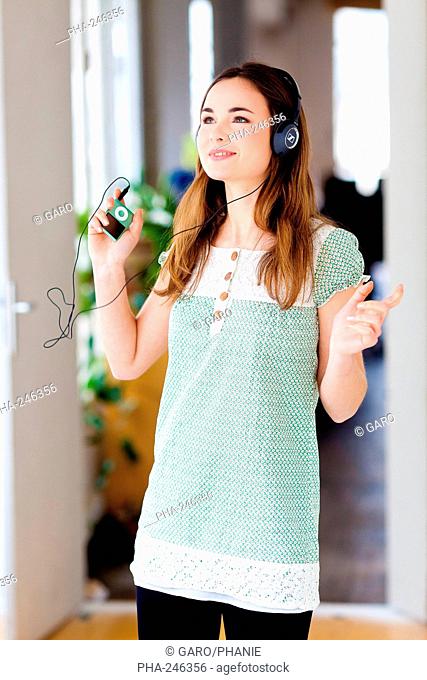 Woman listening to music on an ipod MP3 player