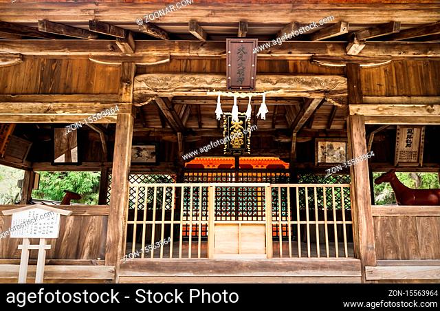 Omoto shrine entrance with dark carved wood at Miyashima island, Japan