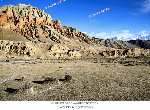 Red and ochre rock formations in a valley near Dhakmar village. Nepal, Gandaki, Upper Mustang (near the border with Tibet)