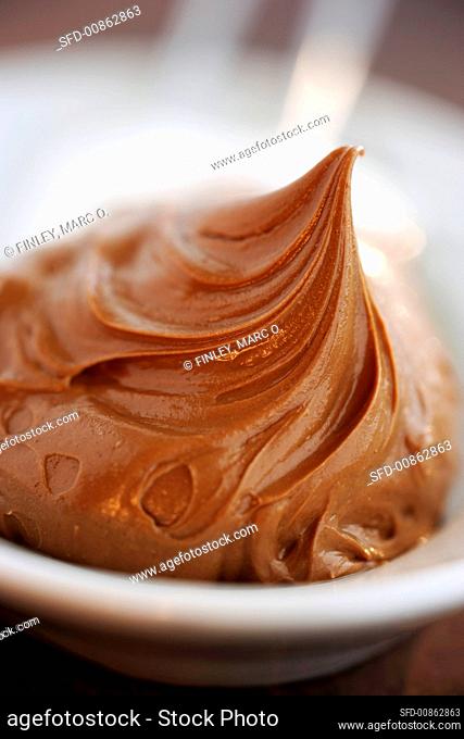 Hazelnut chocolate spread on a china spoon