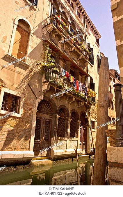 Italian building with balcony and flowers in Venice