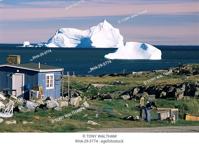 Painted wooden fisherman's house in front of icebergs in Disko Bay, Qeqertarsuaq Godhavn, Disko Island, west coast, Greenland, Polar Regions