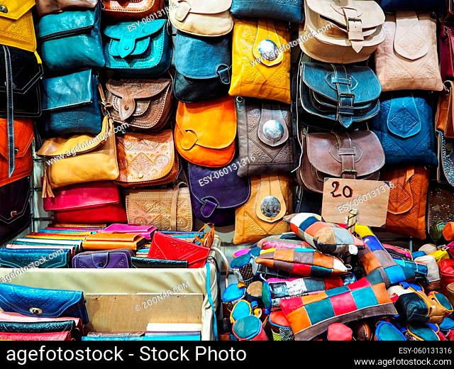 Handmade colourful leather bags and purses on display at traditional souk - street market in Morocco