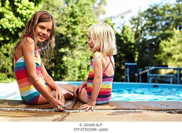 Portrait of two girls at poolside