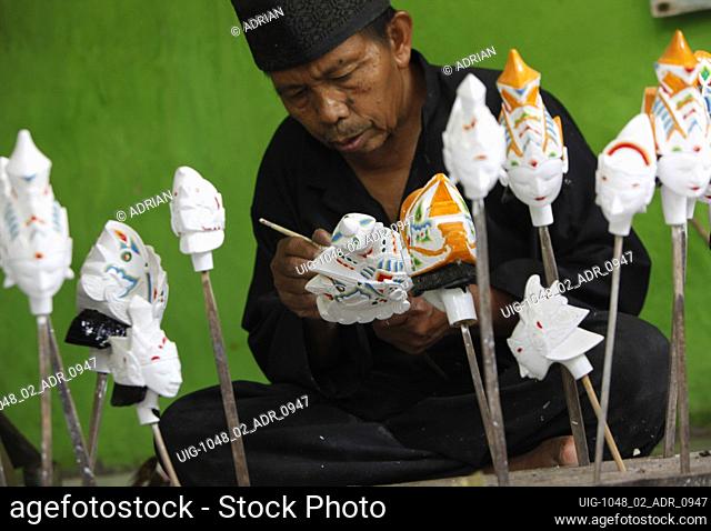 A craftsman Entang Sutisna (73) works on making 'wayang golek' or golek puppet from lame wood (Alstonia scholaris) at the Media Art and Handicraft workshop