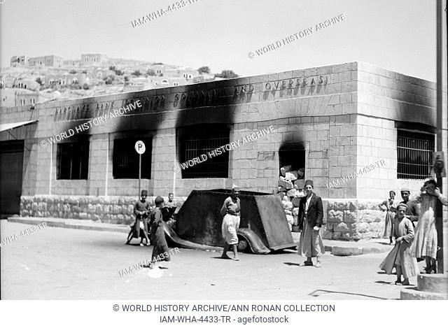 Hebron Attack 1938. Barclay's Bank destroyed by fire after Arab gang attack