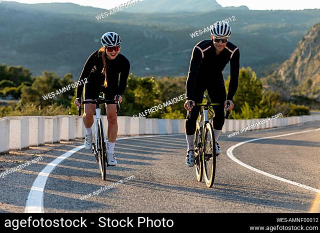 Cyclists cycling with each other on Costa Blanca mountain pass in Alicante, Spain