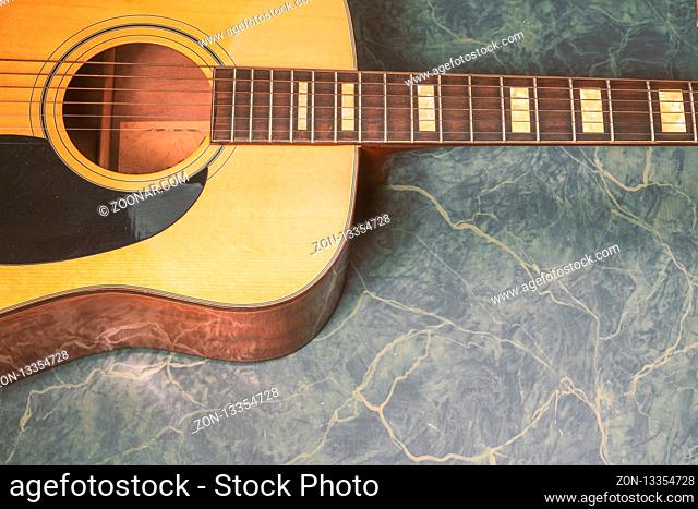 acoustic guitar on green marble background, music concept