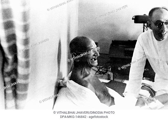 Mahatma Gandhi and Pyarelal Nayar laughing , 1940 , India NO MR
