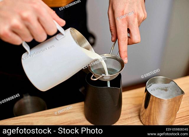 Caucasian man pouring hot milk in coffee. small business concept