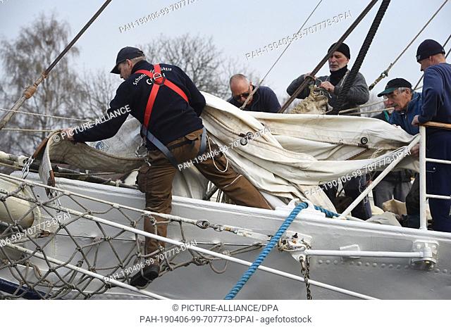 06 April 2019, Mecklenburg-Western Pomerania, Greifswald-Wieck: Sailors climb in the harbour of Wieck near Greifswald in the rigging of the schooner brig...