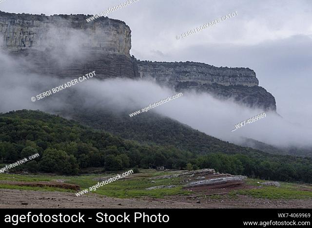 Fog in the Sau reservoir and the cliffs of Tavertet, in the Collsacabra region (Osona, Barcelona, Catalonia, Spain)