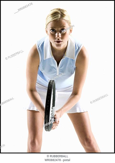 Portrait of a young woman holding a tennis racket
