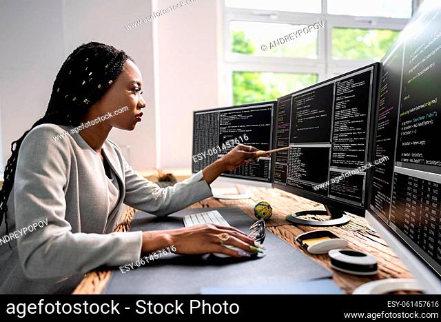 African American Coder Using Computer At Desk. Web Developer