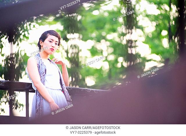 Asian female model poses for pictures in the cityscape