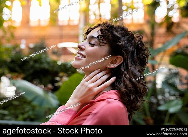 Young woman day dreaming in garden