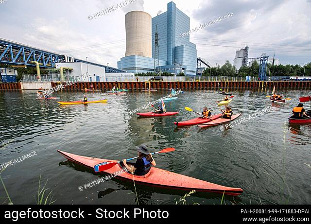 14 August 2020, North Rhine-Westphalia, Datteln: Several climate activists paddle with their boats on the Dortmund-Ems Canal in front of the coal-fired power...