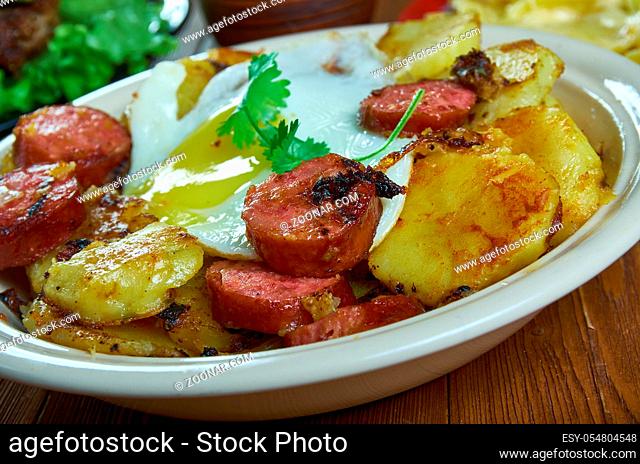 Tiroler Grostl, fried potatoes , bacon and onion. Austrian national cuisine, Traditional assorted dishes, Top view
