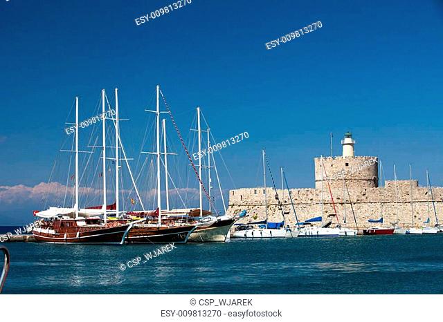 Medieval fortress of Saint Nicholas, now the site of a lighthouse, in Mandraki Harbour, Rhodes New Town, Greece