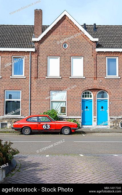 netherlands, limburg province, maastricht, a red car stands in front of a residential building