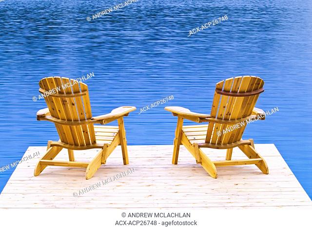 Muskoka chairs on dock at Horseshoe Lake near Parry Sound Ontario