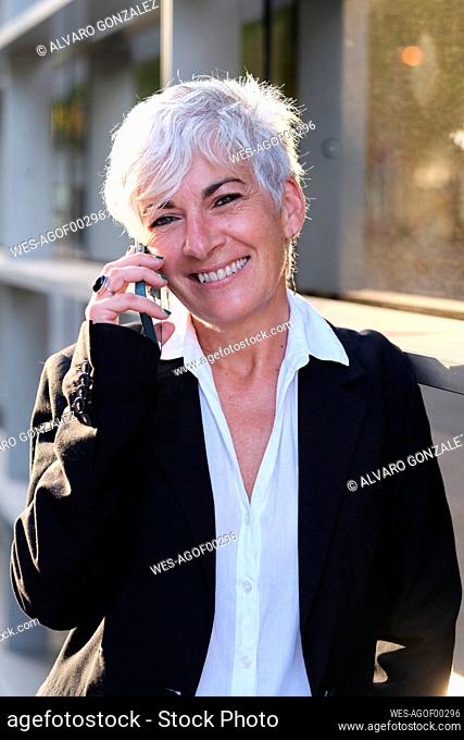 Smiling businesswoman talking on smart phone