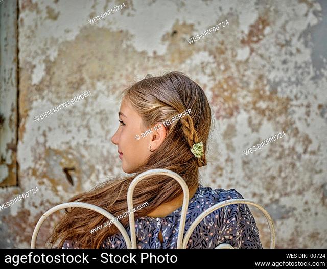 Girl with flower in braided hairstyle at terrace