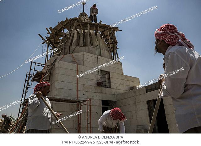 Yazidi men rebuild religious temples in the town of Bashiqa, Iraq on 21 June 2017. The temples were destroyed by the Islamic State after the militants overran...