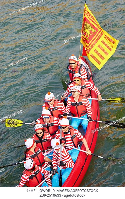 A boat taking part in the Vogalonga, flying a Venetian flag, rows along the Grand Canal. . It is a non competitive race first held in 1975 with the message to...