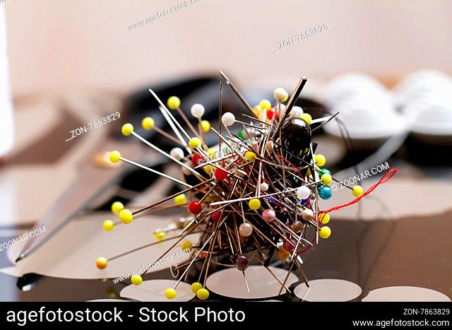 Photo lot of colorful jumbled pins on the table