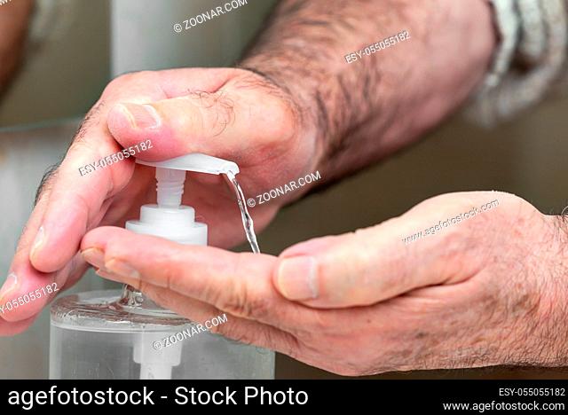 Elderly people , using alcohol antiseptic gel , prevent infection, outbreak of Covid-19. Senior man washing hand with hand sanitizer to avoid contaminating with...