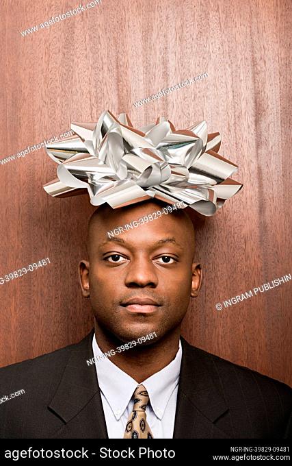 Businessman with bow on his head
