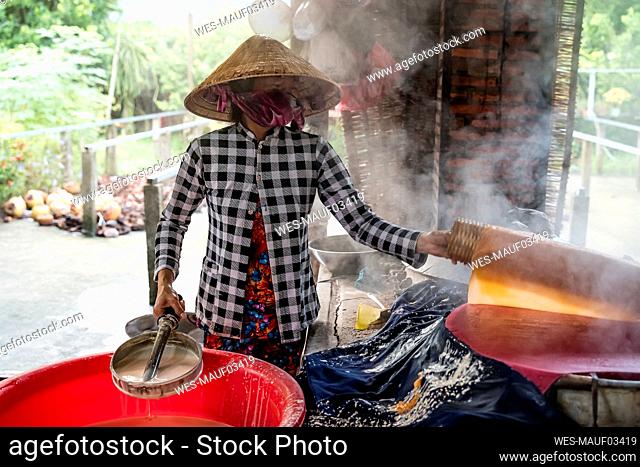 Woman producing noodles at home, Ho Chi Minh, Vietnam