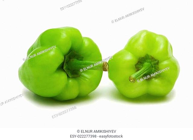 Two green bell peppers isolated on white